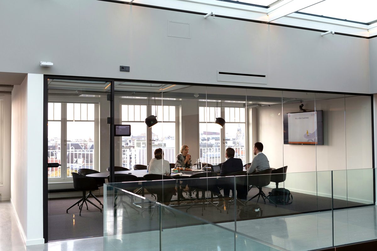 Glass-walled meeting room overlooking the city skyline